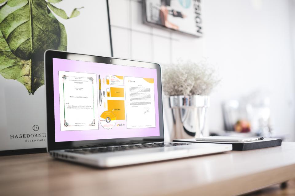 A clean, minimal workspace with a laptop and soft green tones