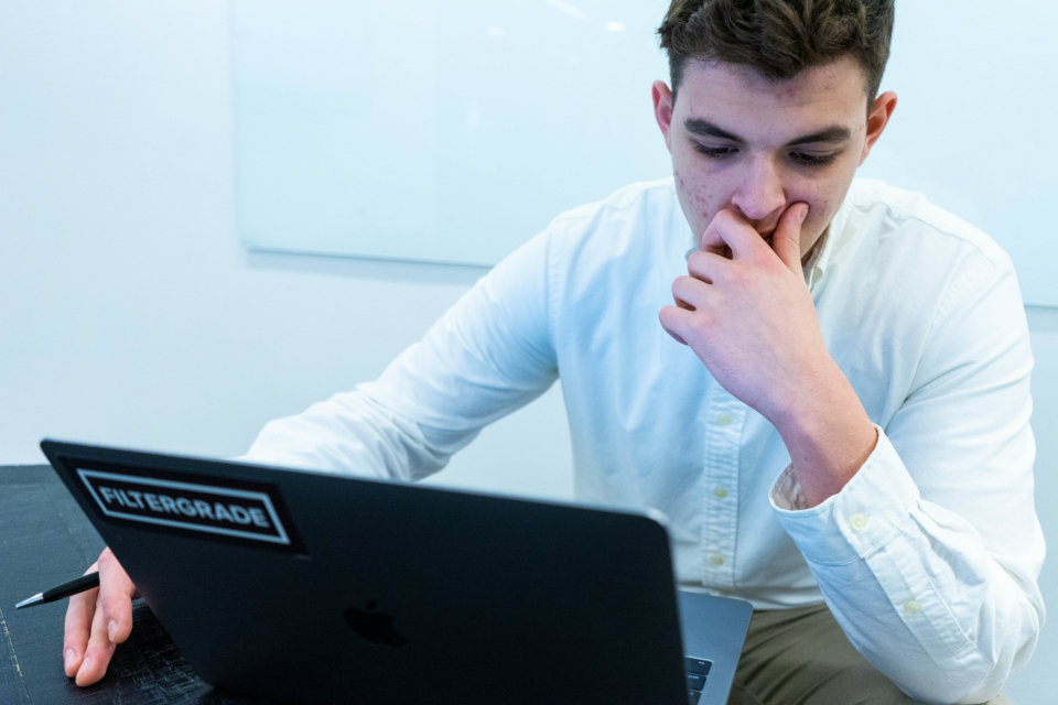 A founder at a laptop weighing which billing stack to run