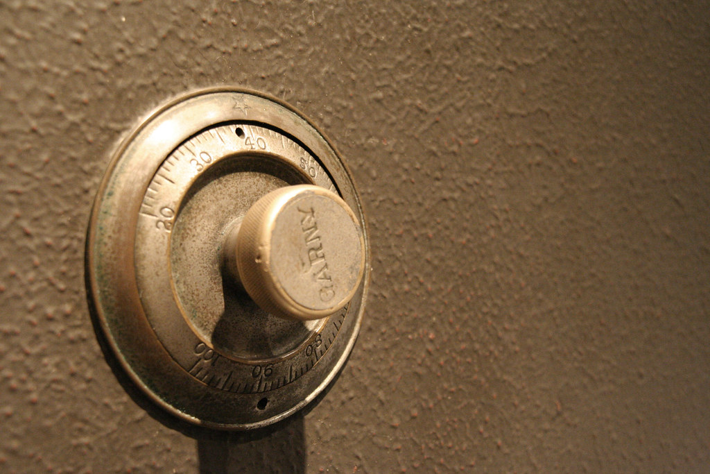 A heavy steel bank-vault door, cool grey — custody, not treasure
