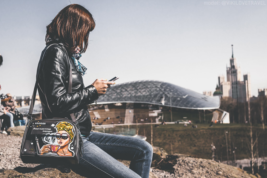 A person holding a phone and completing an in-app purchase