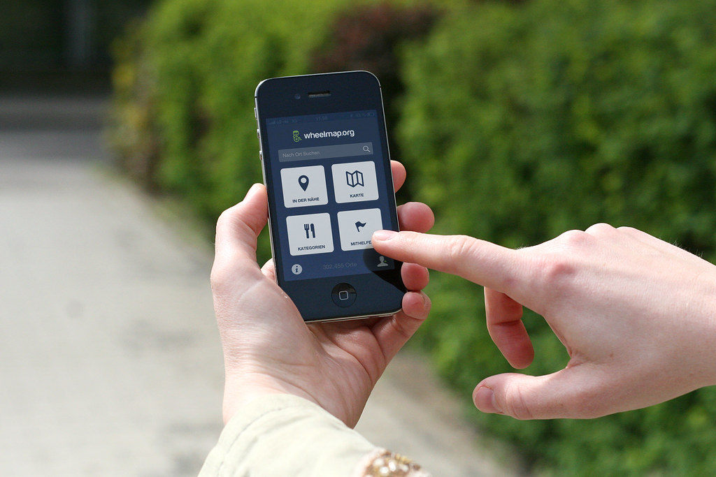 A person holding a phone showing a subscription renewal